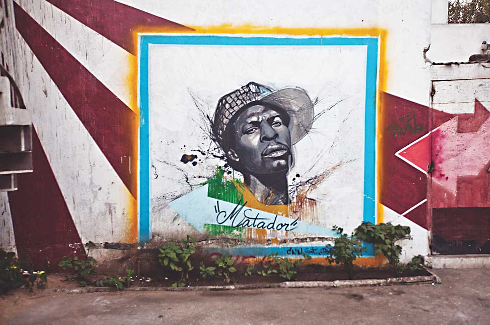 Graffiti mural of longtime political hip hop artist Matador on a wall at the Africulturban Cultural Center in Pikine, just outside Dakar, Senegal. (Photo: Magee McIlvaine)